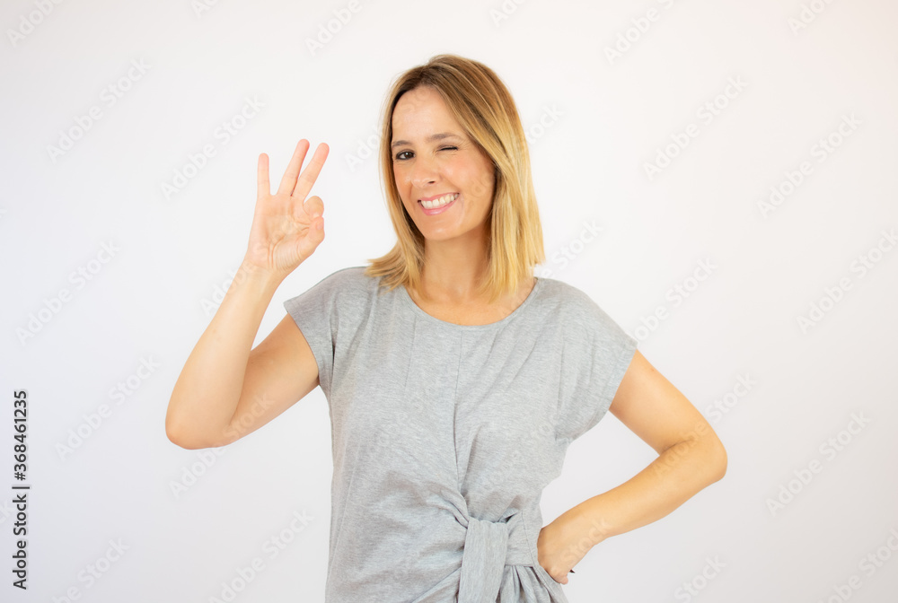 Beautiful woman in grey dress on white background Beautiful woman in grey dress on white background