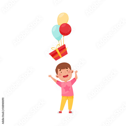 Joyful Boy Character Catching Gift Box with Balloon Vector Illustration