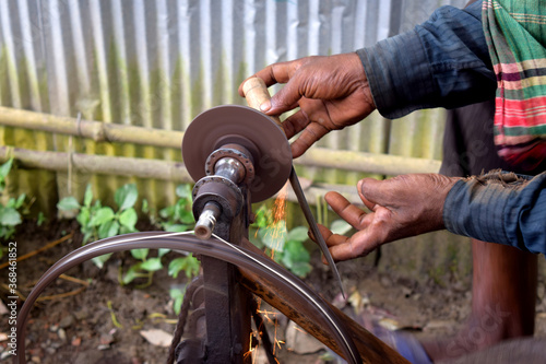 Knife sharpener and hand with matel blade photo