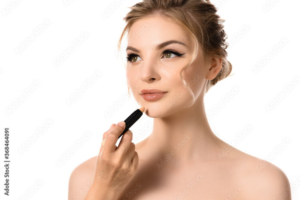 hand with concealer near naked beautiful blonde woman isolated on white