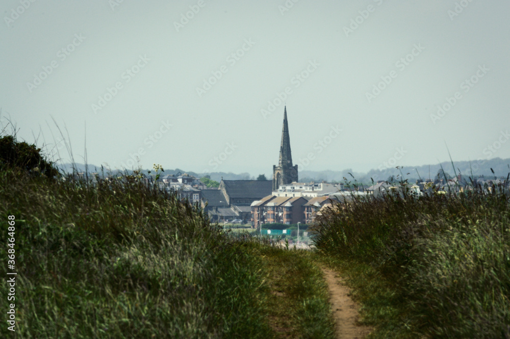 Looking through fields towards Bridlington, East Yorkshire. The coastal town has a focal point of the old church.