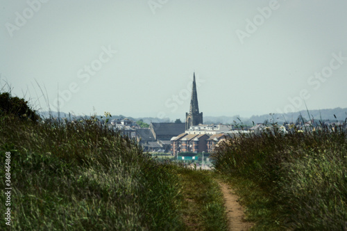 Looking through fields towards Bridlington, East Yorkshire. The coastal town has a focal point of the old church. © Ben