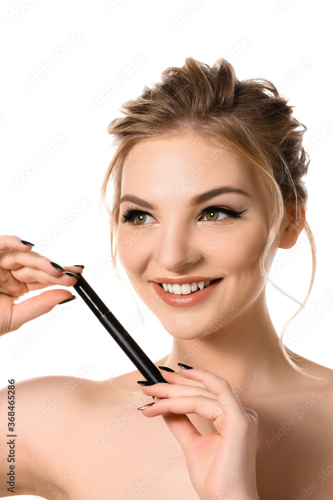 smiling naked beautiful blonde woman with makeup and black nails holding mascara isolated on white
