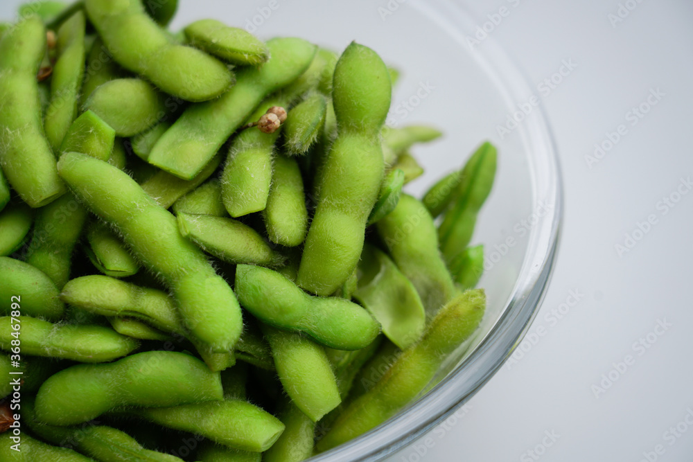 A traditional Chinese delicacy in solid color, boiled soybeans in brine. Chinese traditional food boiled soybean. A traditional Chinese delicacy in solid color, boiled soybeans in brine. Chinese traditional food boiled soybean.