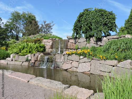 old stone wall, waterfall and pond in Karhula, Finland photo