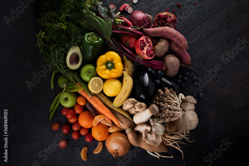 Fruit and vegetable rainbow on dark background photo