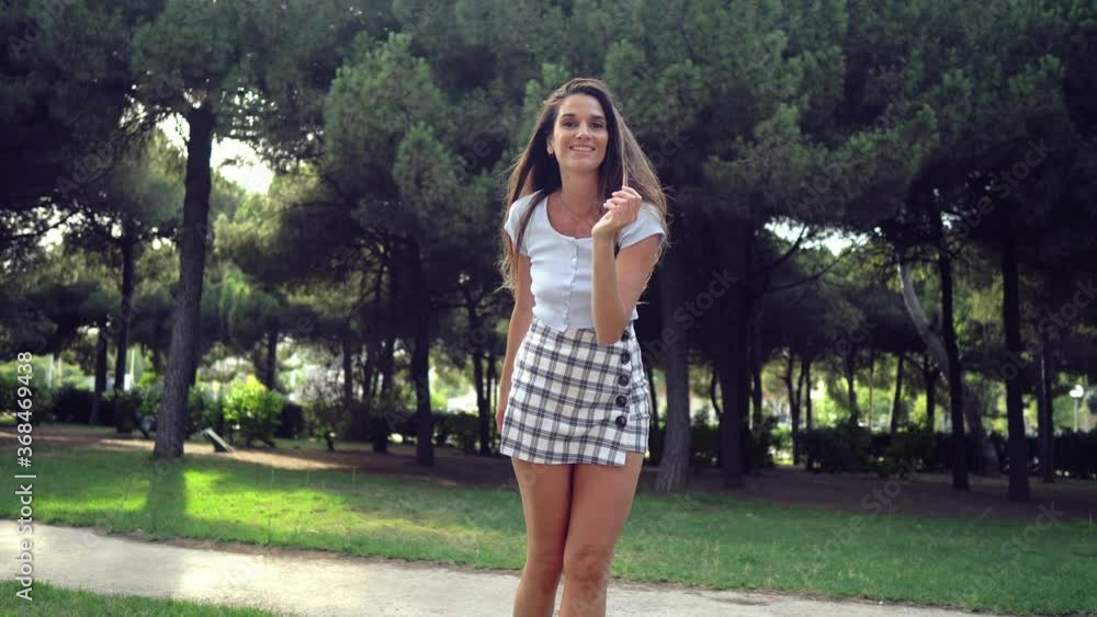 Beautiful young fashionable woman in sexy clothes walking in the green park. Summer concept Beautiful young fashionable woman in sexy clothes walking in the green park. Summer concept