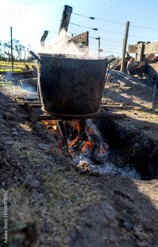 Pots with water boiling over a firewood. Ancient cooking utensils used by the past in rural places.