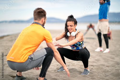 Fitness man and woman running along beach.Enjoying at vacation and exercise at the beach.