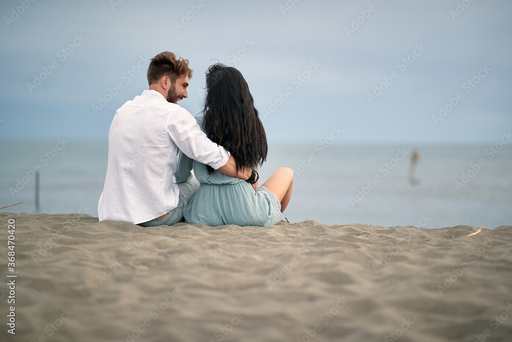 Young couple in love having romantic tender moments on the beach.