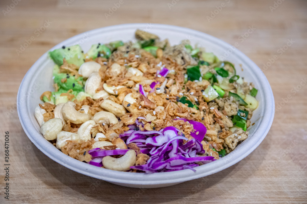 Vegan poke bowl with cashew nuts, red cabbage, dried onions, avocado and much more ingredients Vegan poke bowl with cashew nuts, red cabbage, dried onions, avocado and much more ingredients