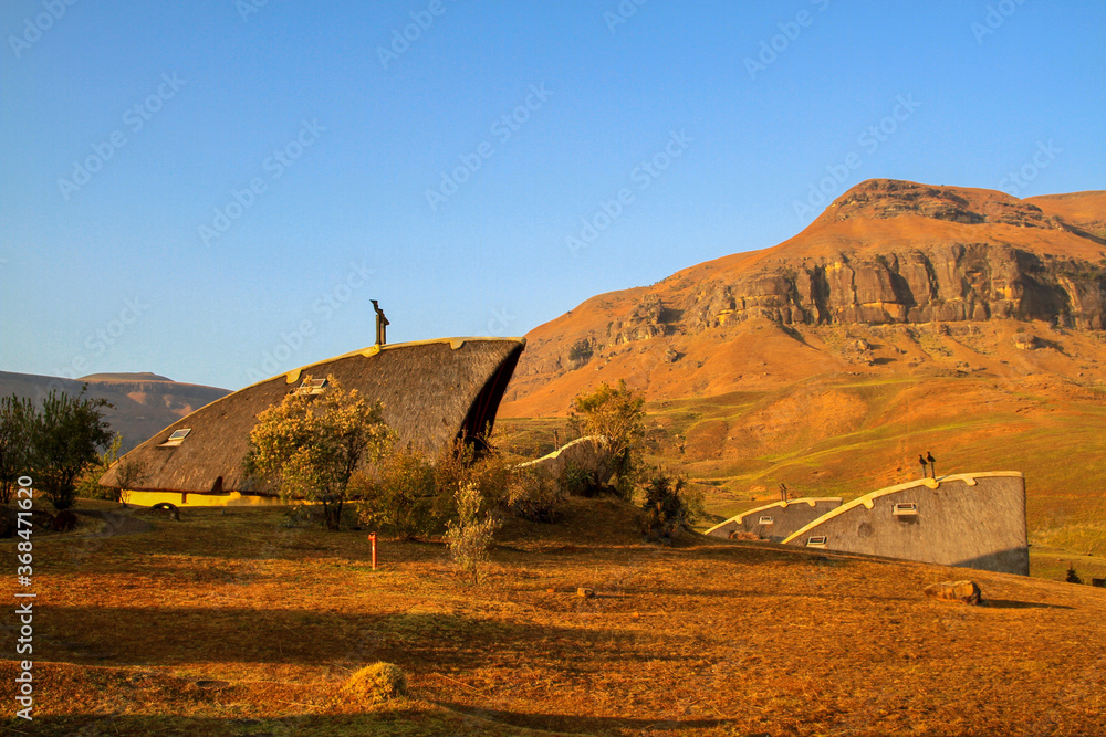 Drakensberg mountains with Didima camp huts, South Africa, setting sun (travel destinations)