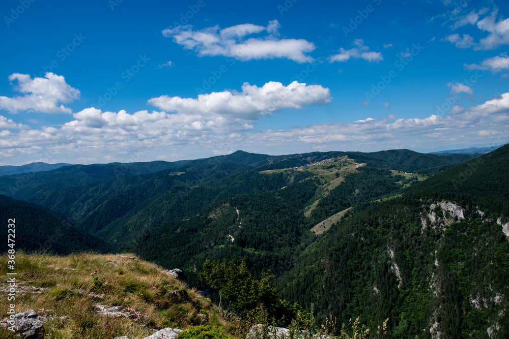 Green mountains in Bulgaria and blue sky with white clouds