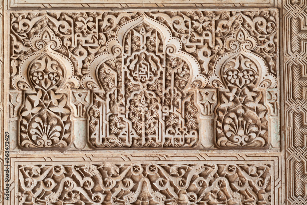 carved wall in Islamic Moorish Style in Alhambra, Granada, Spain carved wall in Islamic Moorish Style in Alhambra, Granada, Spain