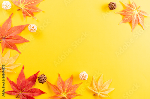 Autumn leaves on yellow paper background. Copy space for text.