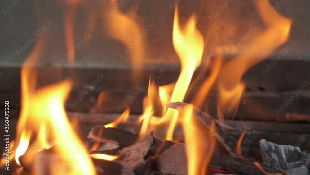 Flaming charcoal on the grill. Camera clouseup, Slow motion Flaming charcoal on the grill. Camera clouseup, Slow motion