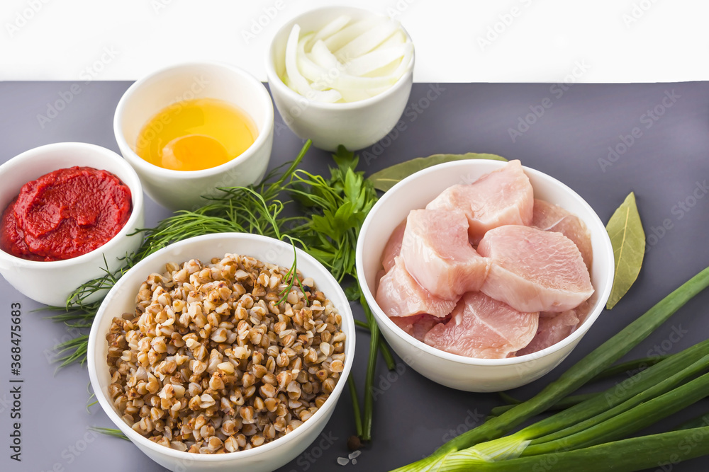 Recipe of cooking buckwheat cutlets or meatballs. Flat lay layout of Ingredients: buckwheat, turkey meat, onion and egg. Homemade food concept. Сopy space for text Recipe of cooking buckwheat cutlets or meatballs. Flat lay layout of Ingredients: buckwheat, turkey meat, onion and egg. Homemade food concept. Сopy space for text