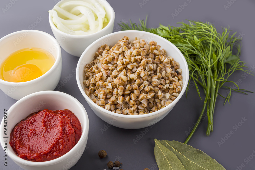 Recipe of cooking vegetarian buckwheat cutlets or meatballs. Flat lay layout of Ingredients: buckwheat, onion and egg. Homemade food concept. Recipe of cooking vegetarian buckwheat cutlets or meatballs. Flat lay layout of Ingredients: buckwheat, onion and egg. Homemade food concept.