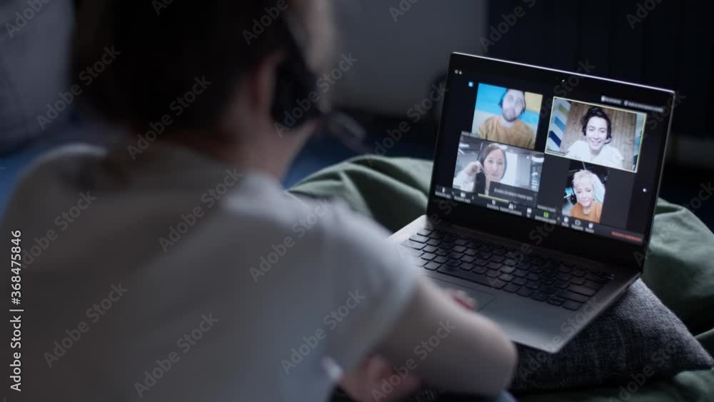 Online Group Video Call Conference of Work Team from Home Office. Woman in Headphones Talks with 3 People at Video Chat using Laptop. Self-isolation at COVID-19 Pandemic. 4K. Online Group Video Call Conference of Work Team from Home Office. Woman in Headphones Talks with 3 People at Video Chat using Laptop. Self-isolation at COVID-19 Pandemic. 4K.