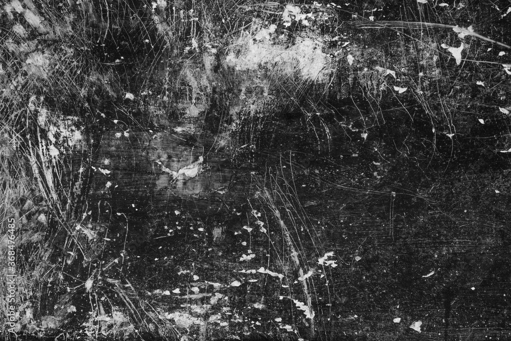 abstract dark black and white grunge background with stains and scratches