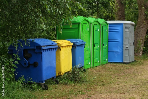 Waste containers and public toilets in a park