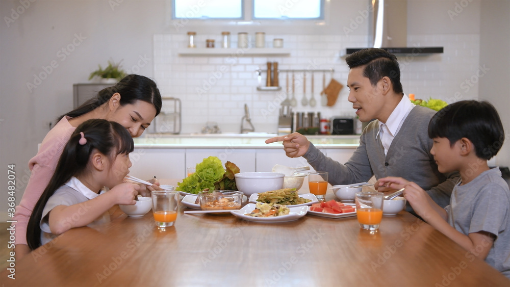 Family concept. The family is eating together happily in the house. 4k Resolution.