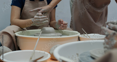 Hand work on pottery wheel, shaping a clay pot