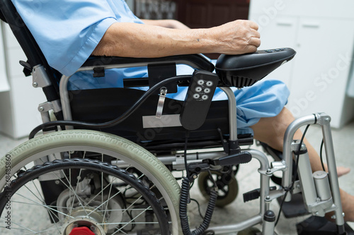 Asian senior or elderly old lady woman patient on electric wheelchair with remote control at nursing hospital ward, healthy strong medical concept