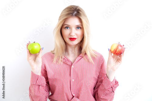 Young beautiful woman holding fresh apples on white background