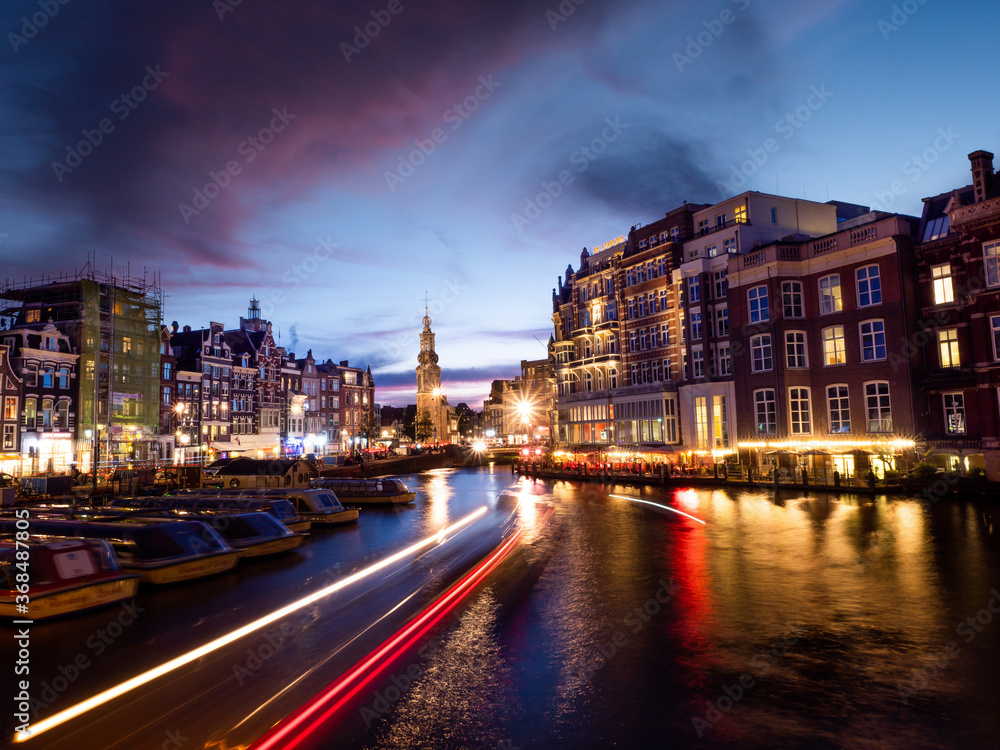 Fototapeta premium Light trails in a Canal of Amsterdam