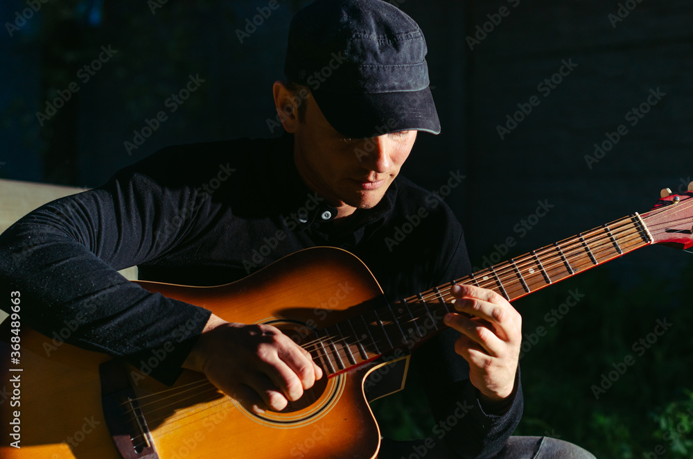 Obraz premium man plays the guitar.