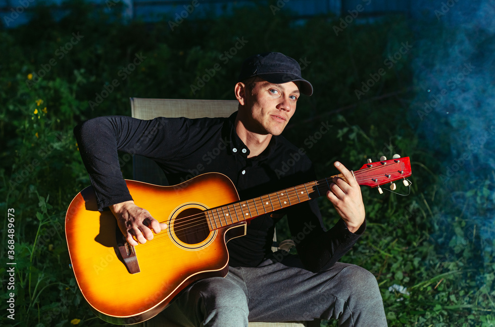 Obraz premium man plays the guitar.