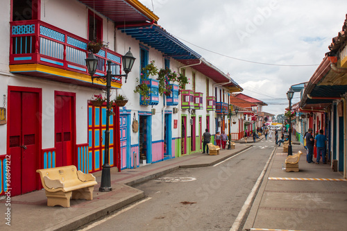 main commercial street with spanish colored balconies and houses at salento, colombia