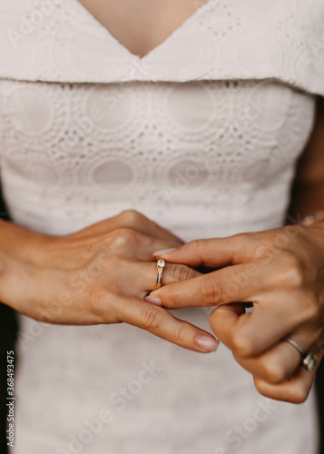 Close up of woman hand adjusting her engagement ring. Engagement concept.