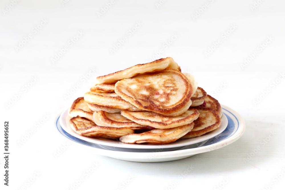 Pancakes in a plate on a white background Pancakes in a plate on a white background