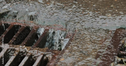Rain flowing into a storm water sewer system. Storm sewer after a heavy rain.