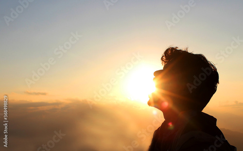 Man Swallowing the Sun.sun rays on the man perspective photography.