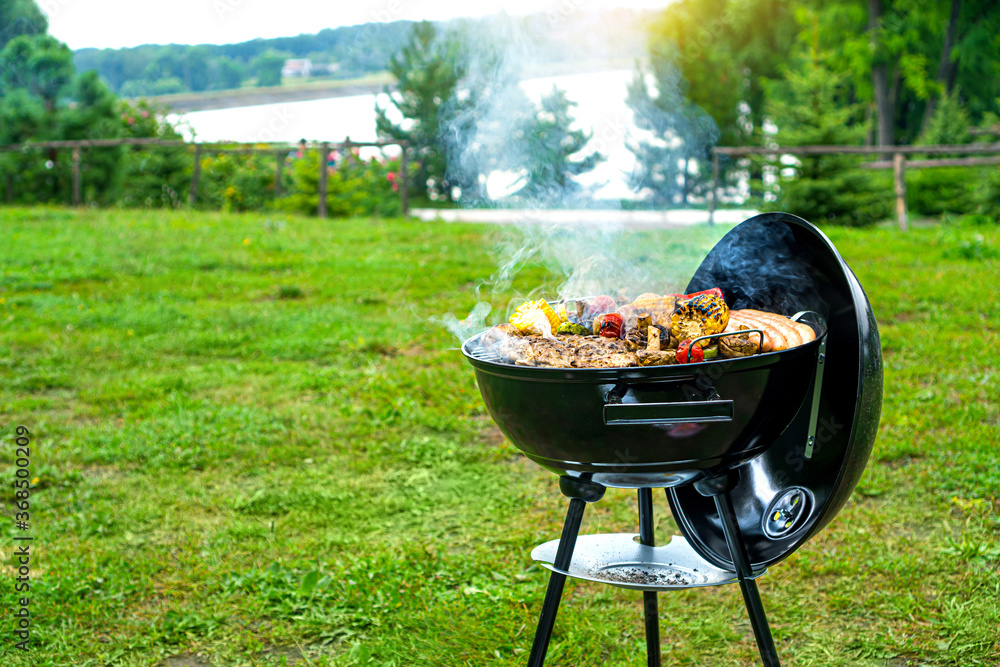Barbecue time at the nature. BBQ grilling on the shore of a picturesque lake. Copy space. Barbecue time at the nature. BBQ grilling on the shore of a picturesque lake. Copy space.