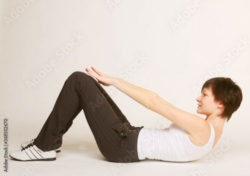 woman doing stretching exercise at the gym