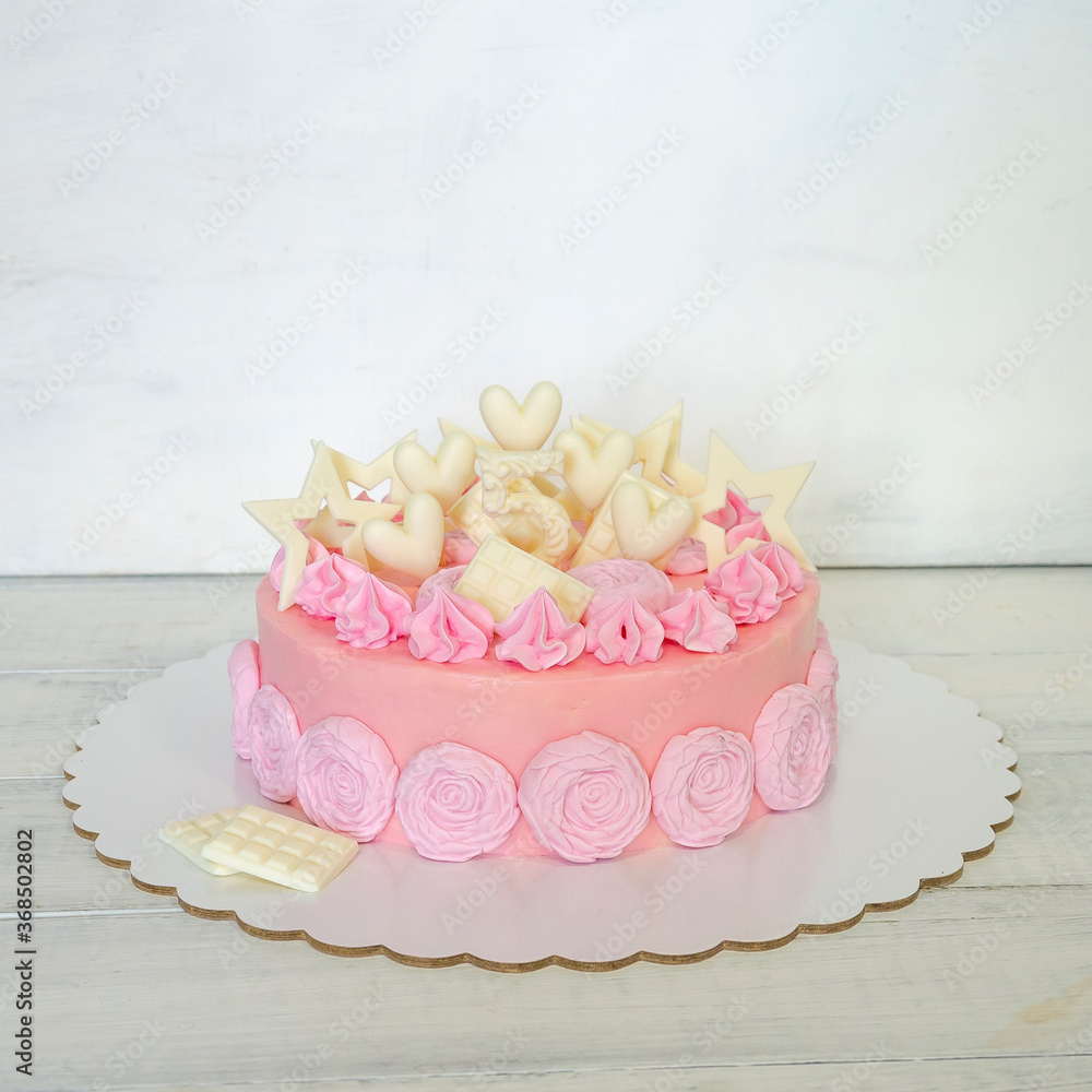 A pink creamchease cake with flowers for 5 year birhtday A pink creamchease cake with flowers for 5 year birhtday