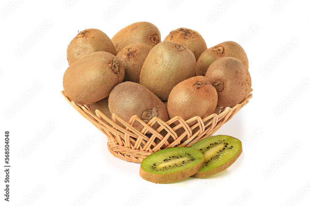 Delicious kiwi in wicker basket with slices isolated on white Delicious kiwi in wicker basket with slices isolated on white