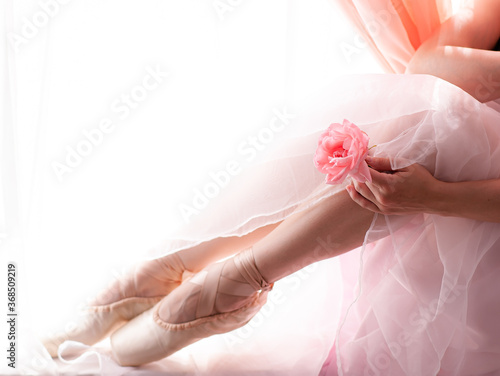 Ballerina feet in classic pointe shoes at the window, ballroom dance class photo