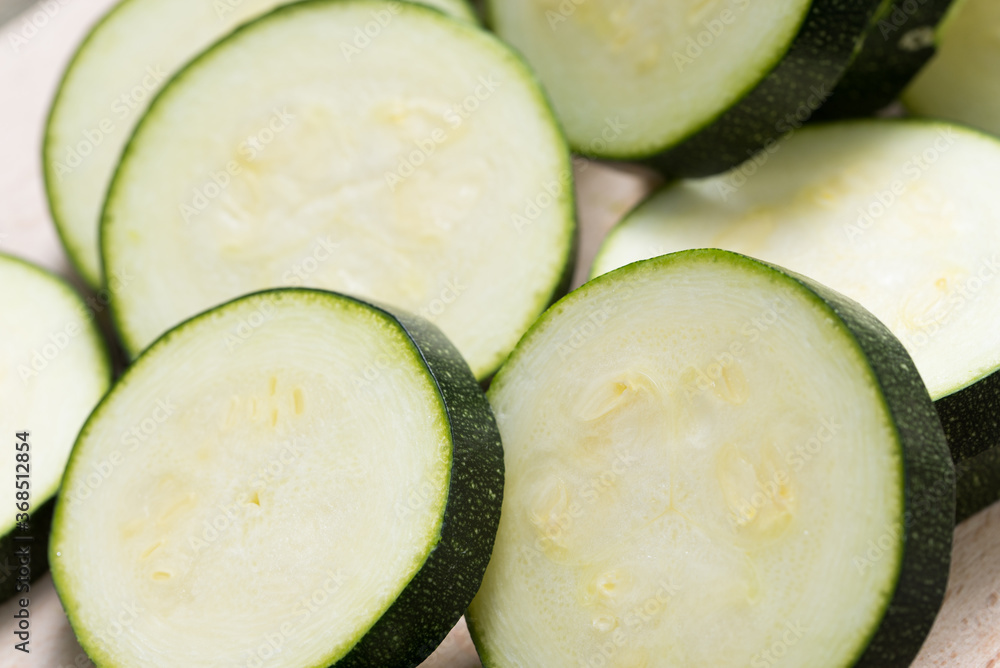 slices of raw zucchini closeup slices of raw zucchini closeup
