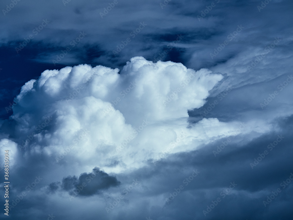 Fototapeta premium Beautiful clouds before the rain float across the blue summer sky.