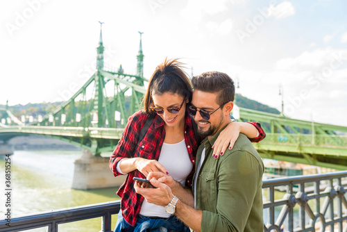 Photography A couple in the city enjoying the content seen of their mobile phone