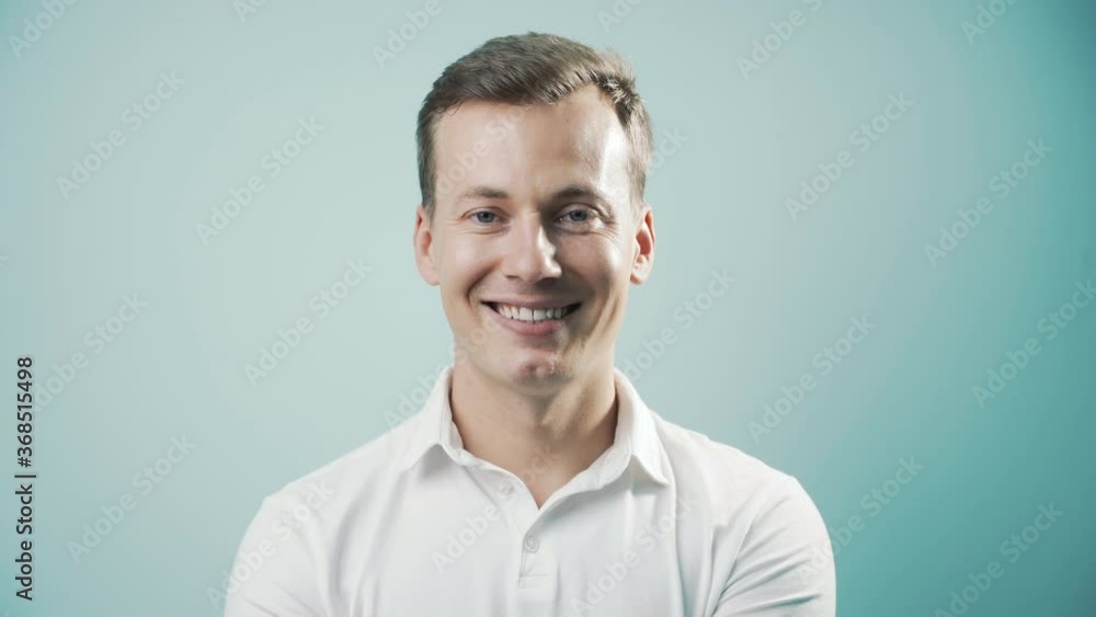 Smiling man with natural white teeth, selective focus. Smiling man face with perfect smile in light blue background. Smile healthy teeth concept, 4k Smiling man with natural white teeth, selective focus. Smiling man face with perfect smile in light blue background. Smile healthy teeth concept, 4k