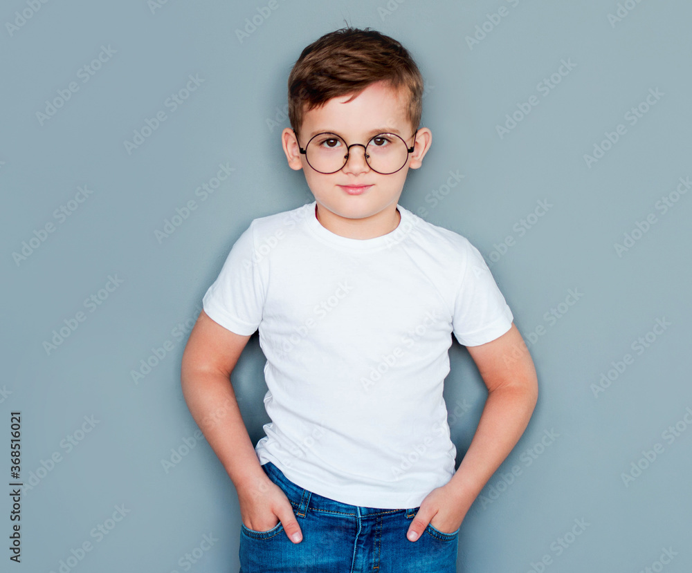Portrait of a little boy with glasses on a gray background Portrait of a little boy with glasses on a gray background