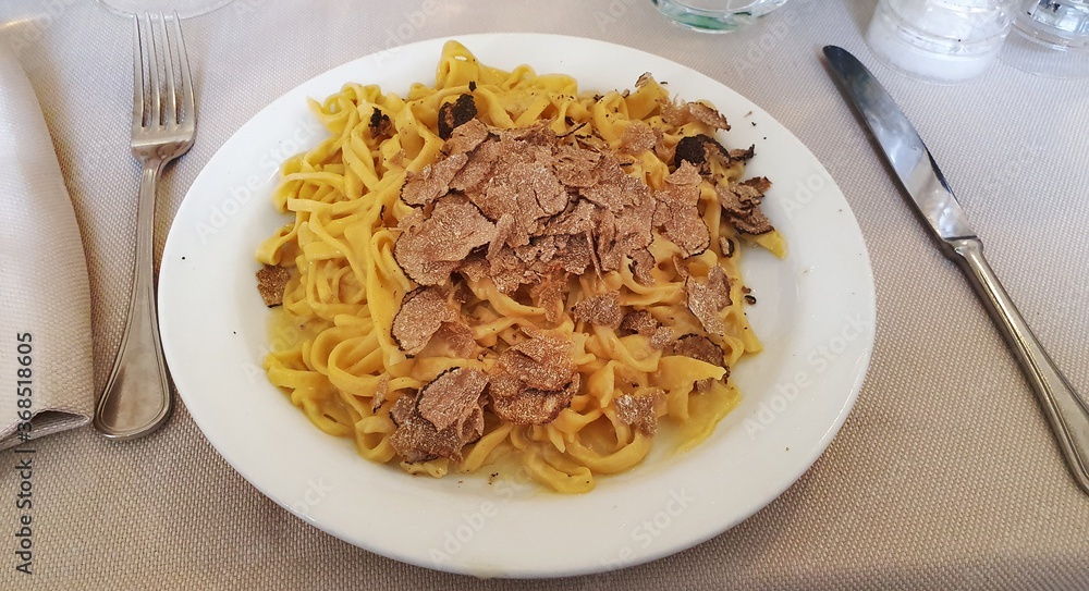Plate of tagliatelle al tartufo, delicious type of Italian pasta.