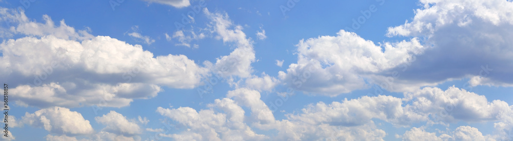 Fototapeta premium Blue sky and clouds, blue sky, panoramic view. Many cumulus clouds in the daytime sky. Sky panorama.