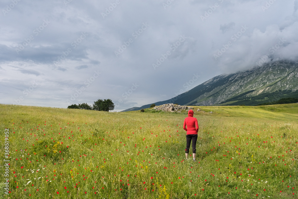 woman looking at the landscape in the san leonardo pass on the majella mountain area in abruzzo woman looking at the landscape in the san leonardo pass on the majella mountain area in abruzzo